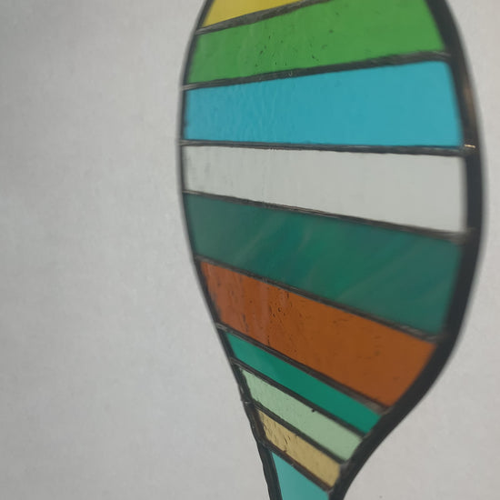 Stained glass hot air balloon suncatcher with stripes.
