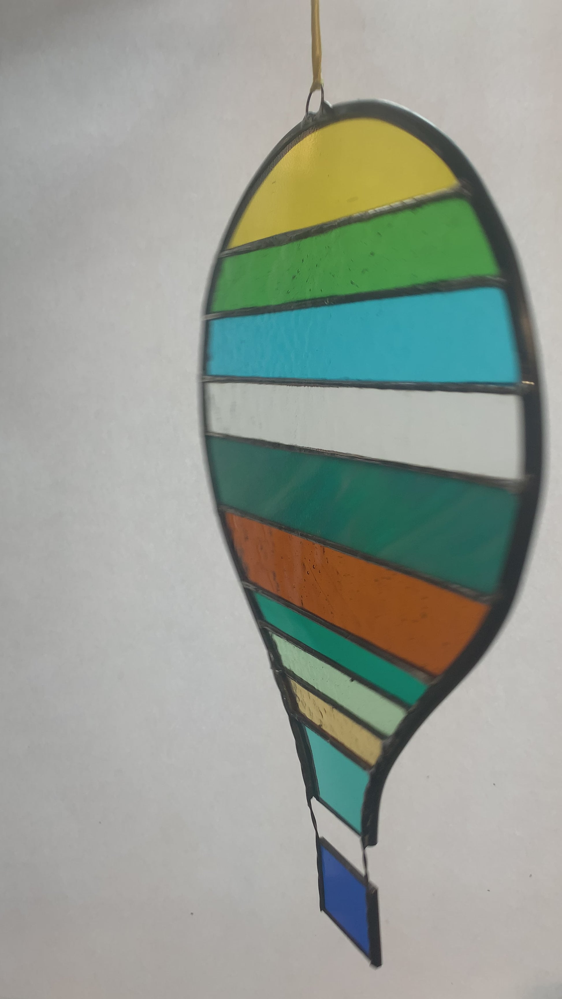 Stained glass hot air balloon suncatcher with stripes.