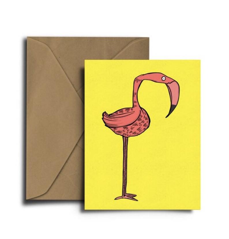 Glass Designs Dixon Does Doodles card with a pink flamingo on a yellow background