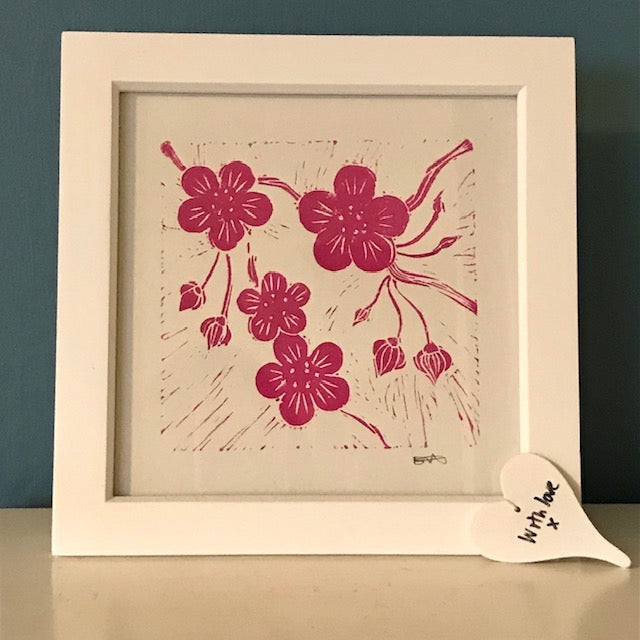Pink blossom lino print framed in a white frame