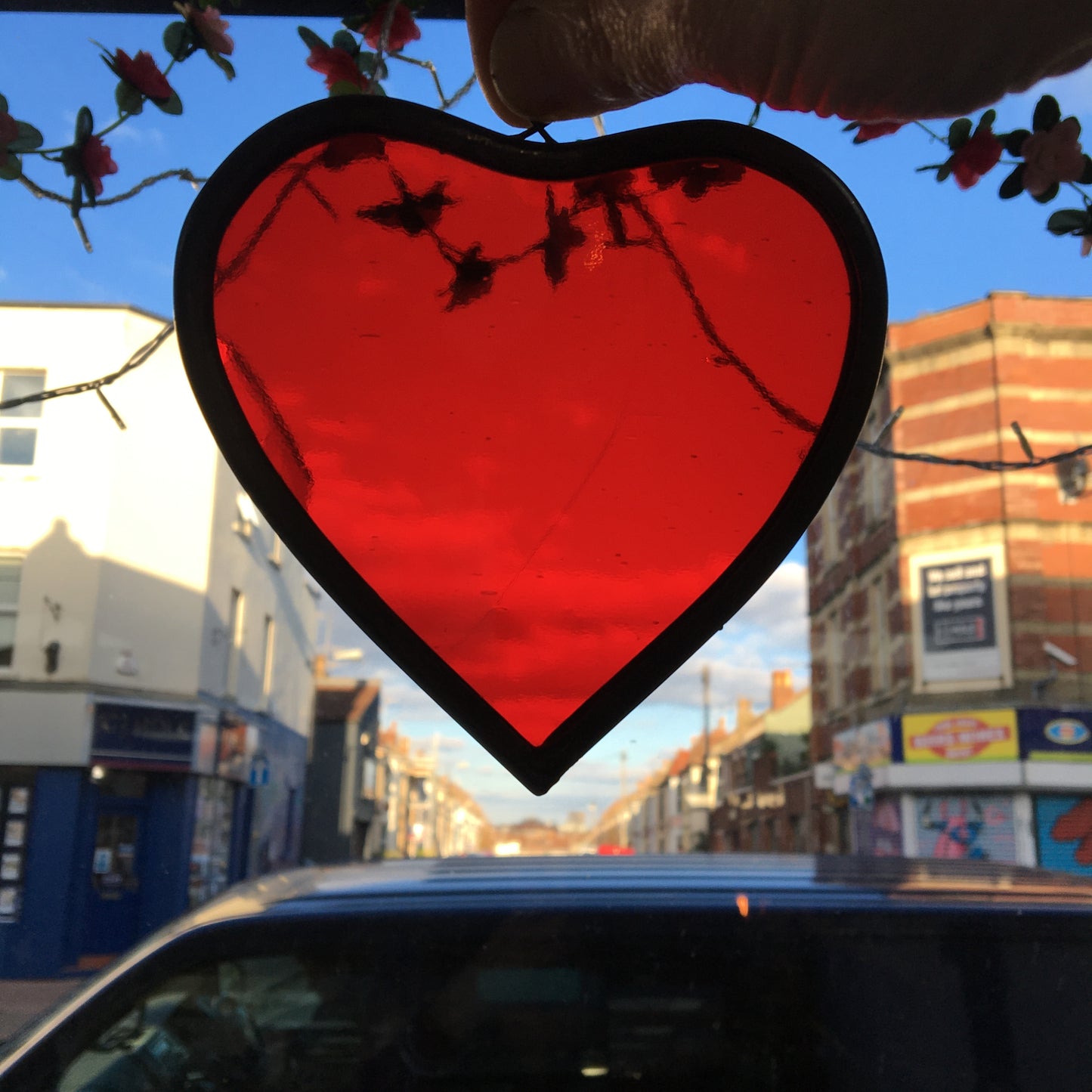 A medium sized Glass heart with a lead edging and a copper wire hook to hang in a window or outside in a tree.