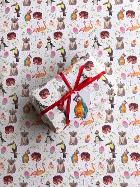 Party theme colourful wrapping paper with a variety of animals and birds in party hats