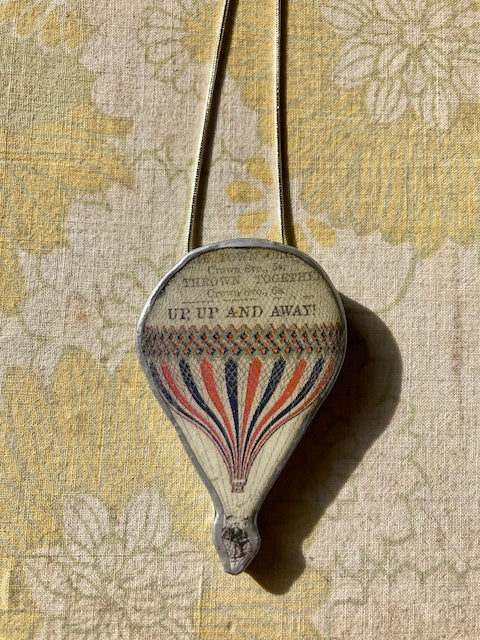 Cardiff based artist Ellymentals whimsical layered paper, metal and resin hot air balloon pendants. Small medium or large available.