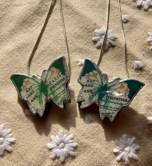 Quirky Butterly Pendants made from Layered paper, metal and resin, chain is 18 inches and silver plated.