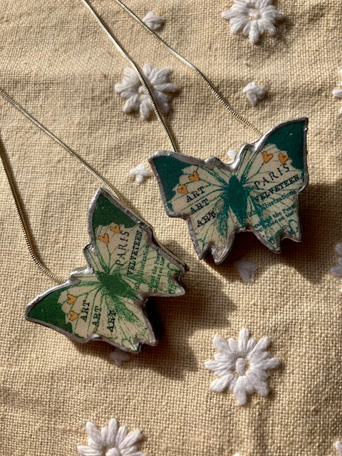 Quirky Butterly Pendants made from Layered paper, metal and resin, chain is 18 inches and silver plated.