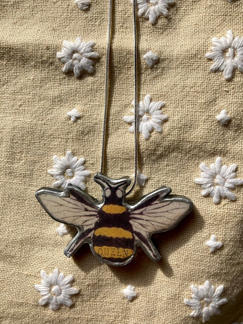 Bumble bee pendant, made from layered paper., metal and resin. Handmade in Cardiff.