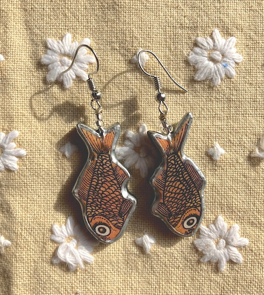 Quirky goldfish Earrings.  Handmade by layering paper, metal and resin.  Surgical steel ear hooks.