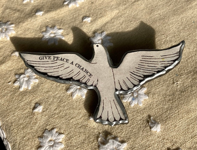 Give Peace a Chance dove brooch. Made from layered paper and metal with resin to seal.