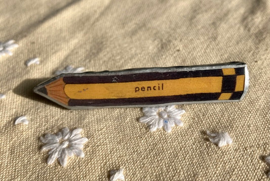 Whimsical pencil brooch, made with layered paper, metal and resin. handmade in Cardiff by Ellymental.