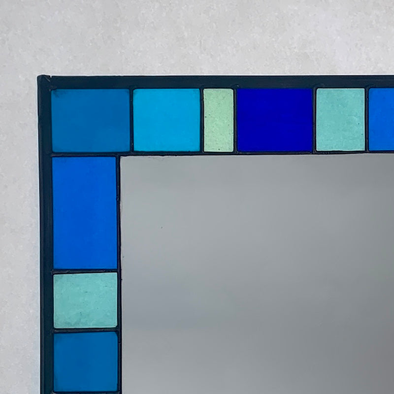 Stained Glass Mirror in Blues and Aqua colours randomly placed round edge of mirror. 40cm x 60cm with a 6 cm border.