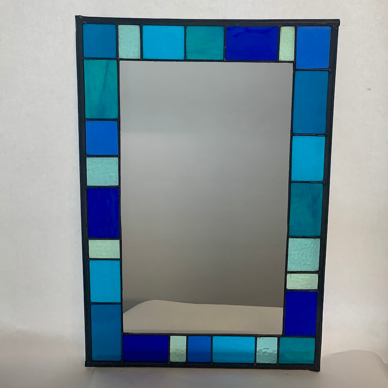 Stained Glass Mirror in Blues and Aqua colours randomly placed round edge of mirror.  40cm x 60cm with a 6 cm border.