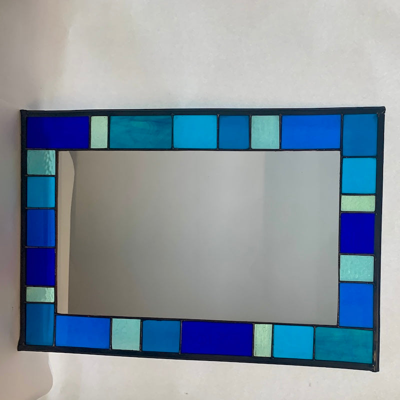 Stained Glass Mirror in Blues and Aqua colours randomly placed round edge of mirror. 40cm x 60cm with a 6 cm border.