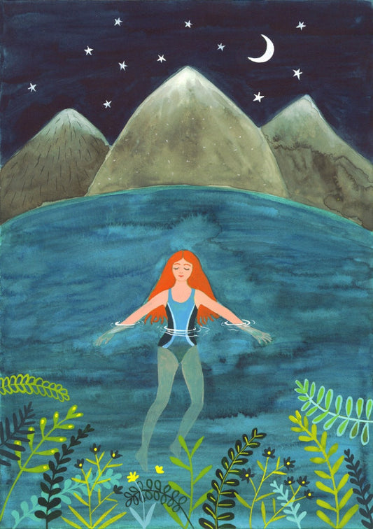 Red haired woman in bathing costume swimming in a lake at night.