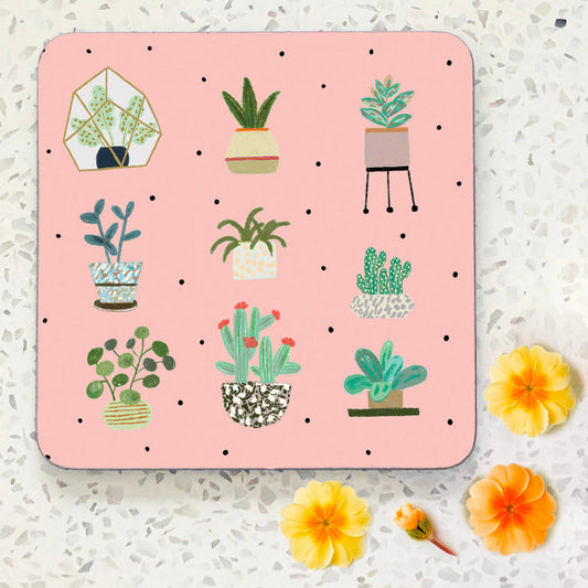 Hand illustrated coaster. Pale pink background with nine plants and cacti in pots.