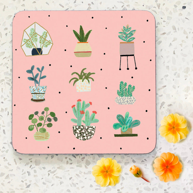 Hand illustrated coaster. Pale pink background with nine plants and cacti in pots.