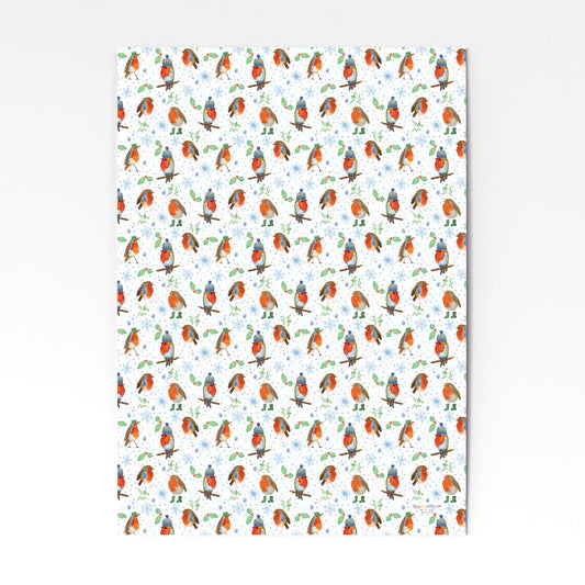 Colourful Christmas wrapping paper with robins in wooly hats and boots with snow flakes and holly