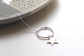 Sterling silver necklace with a silver hoop and hanging star