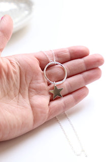 Sterling silver necklace with a silver hoop and hanging star