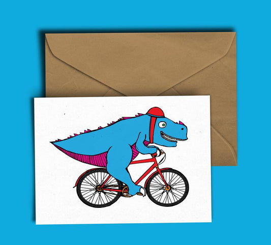 Glass Designs Dixon Does Doodles card with a blue t-rex dinosaur in a helmet riding a small red bike 