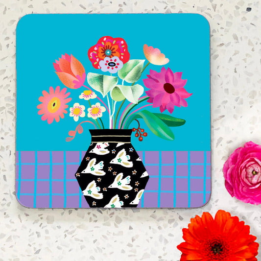 Coaster with red and pink flower bouquet in a black vase with white doves illustration. Medium blue background