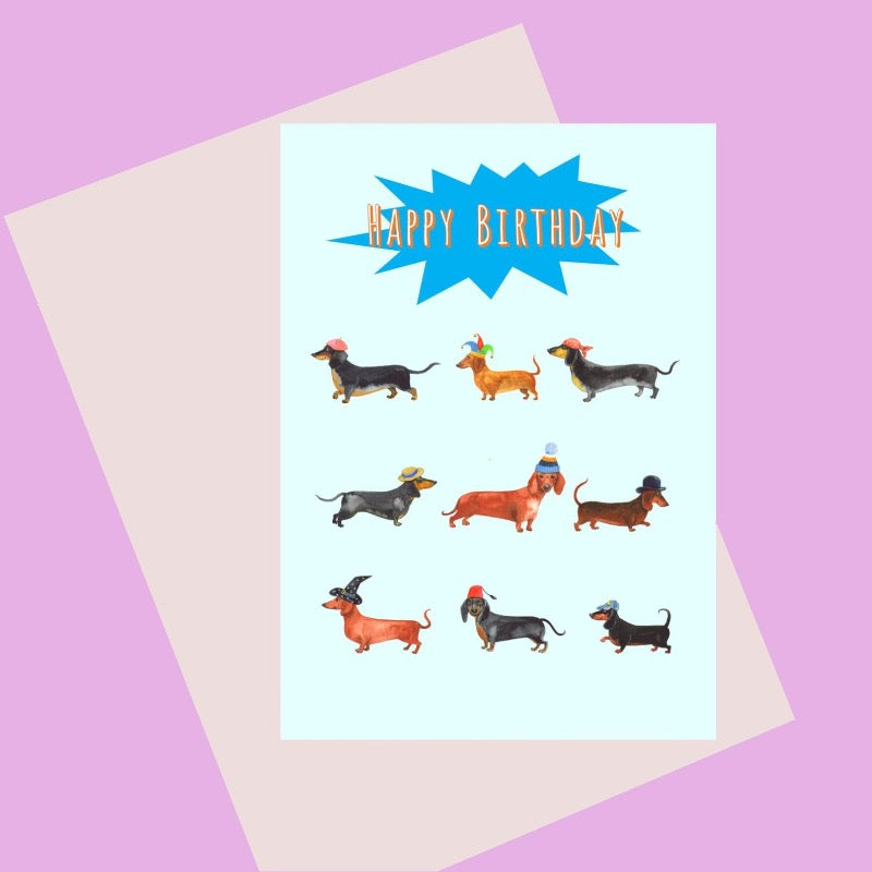 Birthday card with illustration of nine dachshunds with different hats