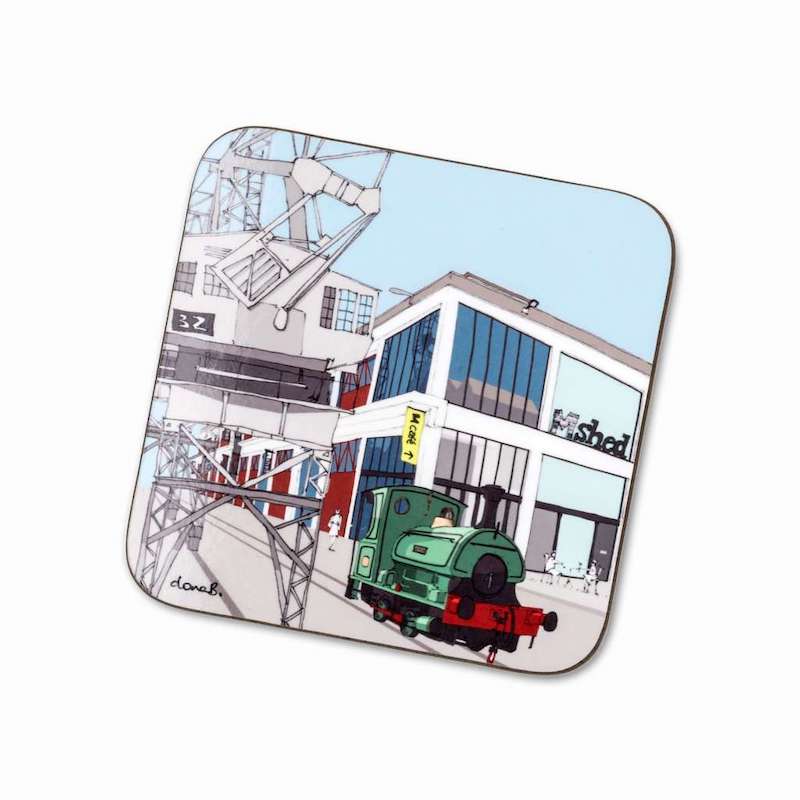 A coaster with an illustration of the Shed museum, crane and steam engine.