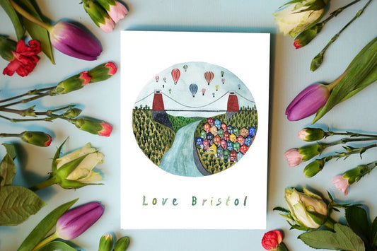 watercolour greetings card with design of Bristol Bridge, Hot air ballons and colourful houses with the words ''love Bristol''