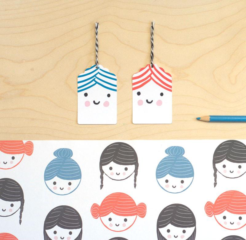 Sarah Ray Gift Wrap, Drawn faces with different hair styles.  Bobs, plaits or buns.