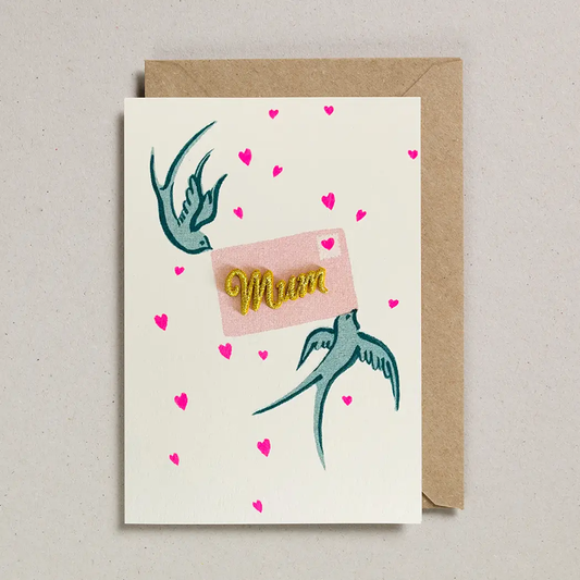 Mum Card with two swallows holding a letter  with a gold embodied mum in the centre. Card