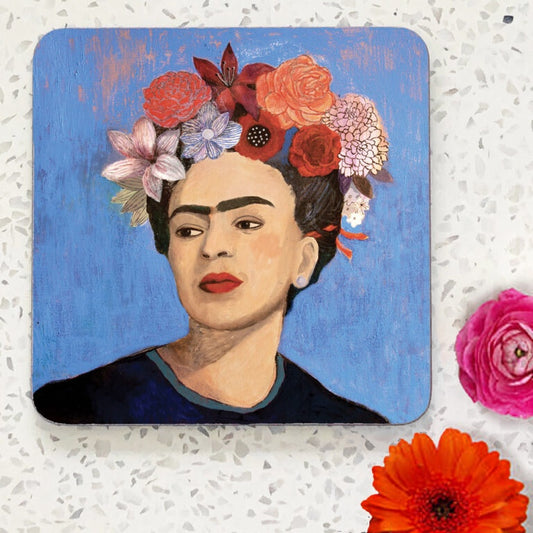Coaster with portrait painting of Frida Kahlo with pink flowers in her hair and blue background
