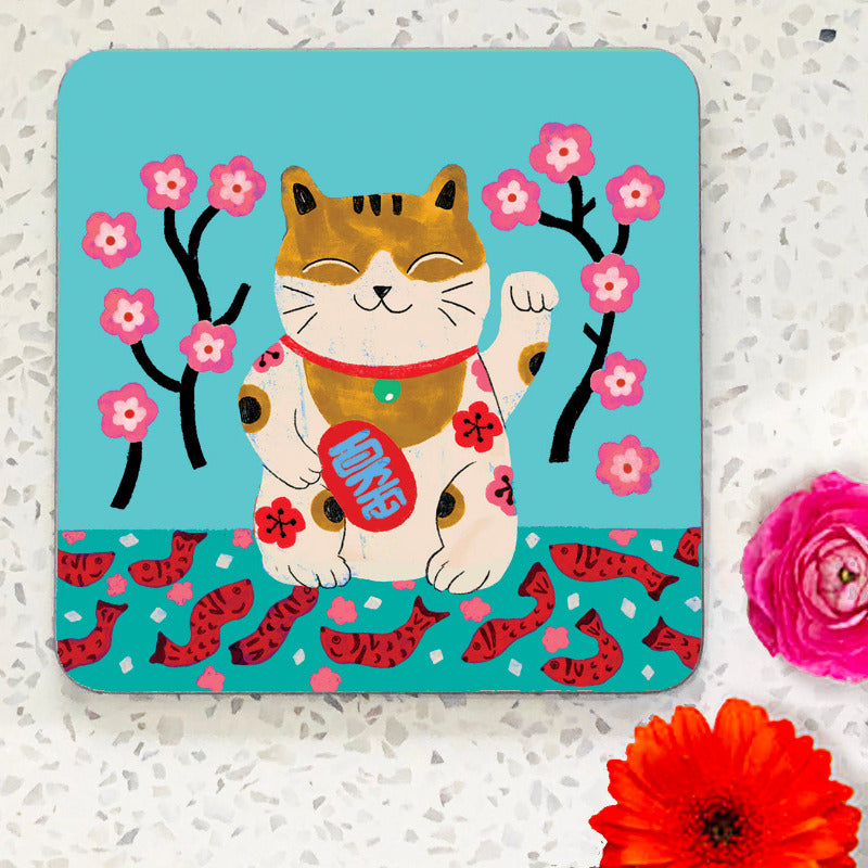 Coaster with smiling cat illustation on teal background