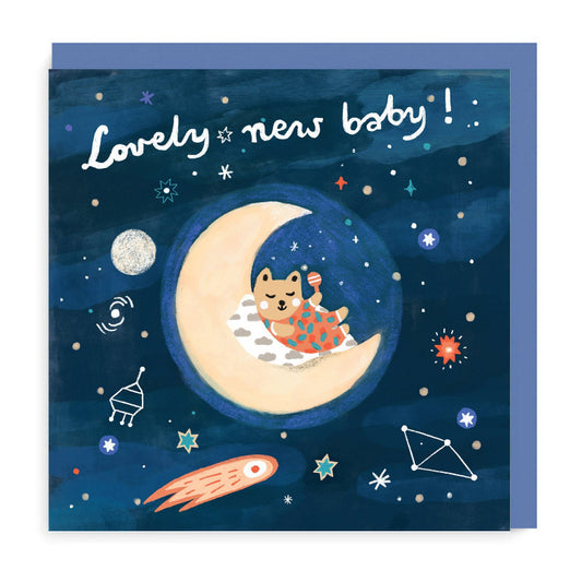 Lovely new baby message card. Illustration is kitten sleeping on crescent moon surrounded by stars in space. Dark blue background.