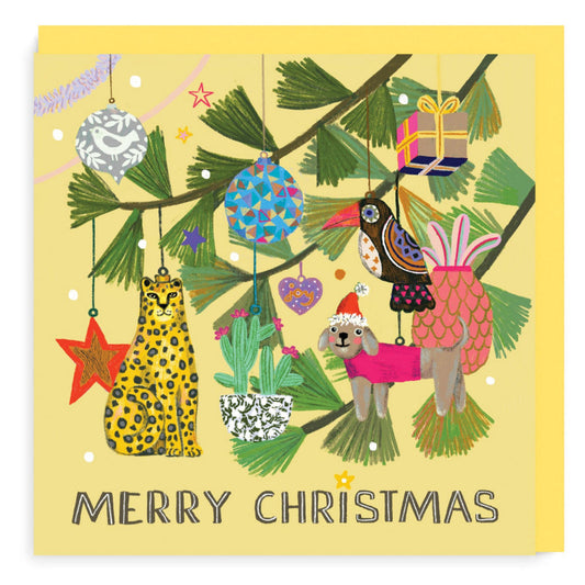 Merry Christmas card. Colour illustration of tiger, dog, pineapple, star, heart and cactus baubles hang from christmas tree branch. Pale yellow background.