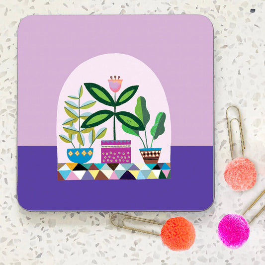 Coaster with three potted plants on lilac and purple background